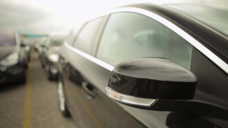 Panning shot of a line of parked cars with a shallow focus and a blurry background