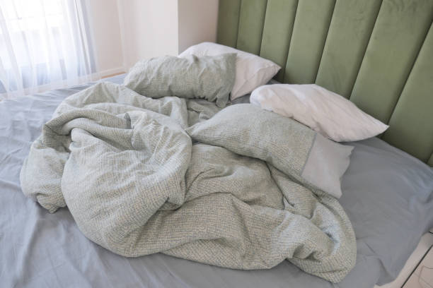 istock messy bed in early morning , messy bed after waking up 2162959748