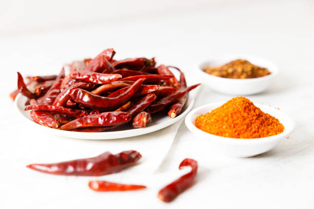 istock Dried red chilies on white wooden table. 2162962777