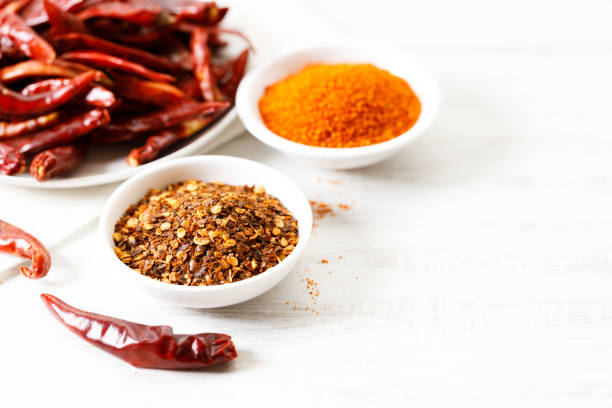istock Dried red chilies on white wooden table. 2162962778