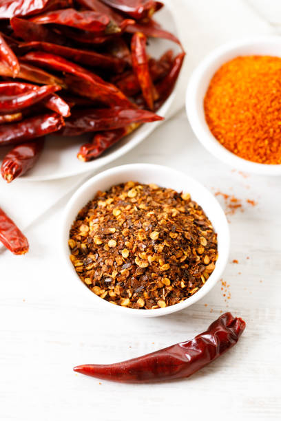 istock Dried red chilies on white wooden table. 2162962781