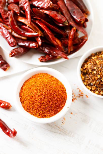 istock Dried red chilies on white wooden table. 2162962782