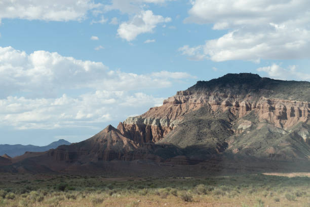 A breathtaking contrast of rugged desert terrain and snow-capped peaks, this image captures the La Sal Mountains rising above the rocky, arid formations of the American Southwest. The clear blue sky, scattered clouds, and expansive view highlight the diverse topography of this region, blending high-altitude alpine beauty with a sunbaked desert. Perfect for themes of nature, adventure, exploration, and scenic landscapes, this photo showcases the unique beauty of Utah’s wilderness.