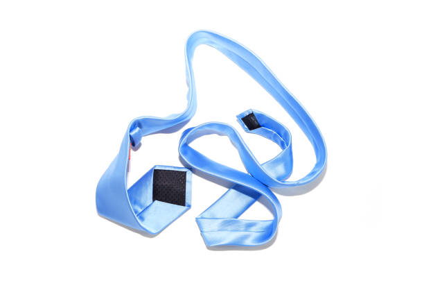 A blue color necktie randomly placed on white background close-up top down view