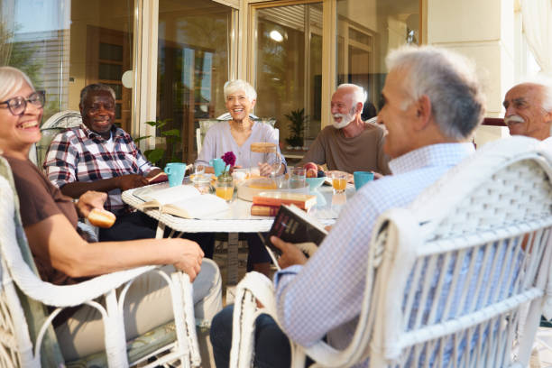 istock Diverse senior friends talking during social gathering on a terrace. 2162964287