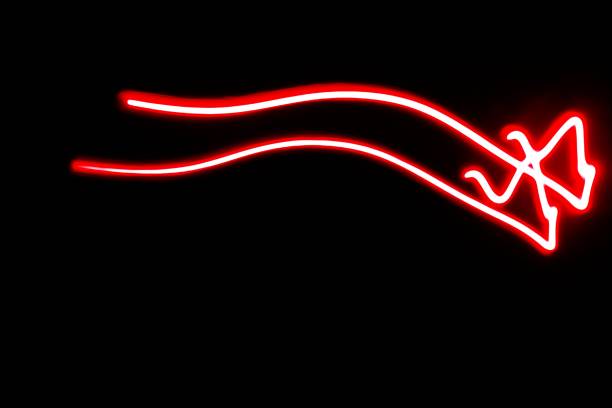Blurred red neon lights.  Overlay of colored light.  Disco lighting.  Soft texture of unfocused red ultraviolet light on dark abstract empty space background