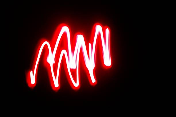 Blurred red neon lights.  Overlay of colored light.  Disco lighting.  Soft texture of unfocused red ultraviolet light on dark abstract empty space background
