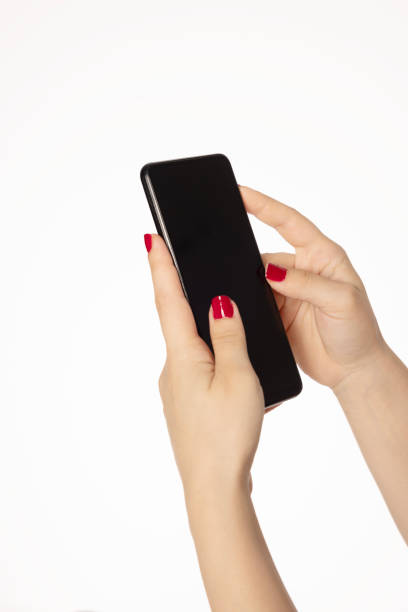 woman's hand with red nail polish holding a phone