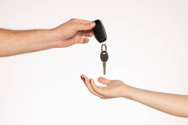 istock Car salesman handing keys to customer 2162965742