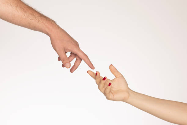 Male and female hands holding tight together on black isolated background. Love, relations, support, together forever concept. Copy space, cutout, low key
