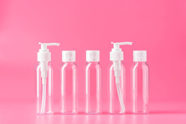 istock Five Clear Plastic Travel Bottles With White Pumps and Caps on Pink Background 2162966674