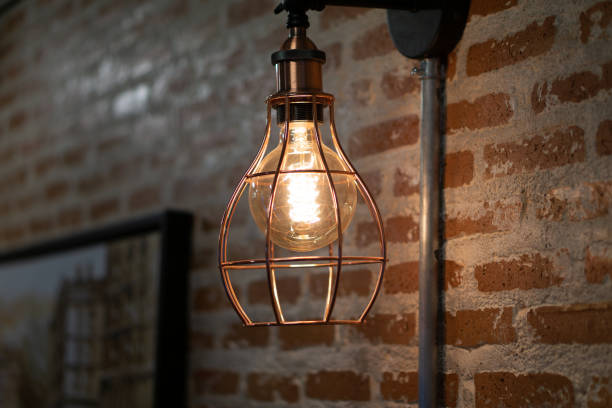 istock Vintage Industrial Hanging Lamp Glowing in Rustic Brick Interior 2162966898