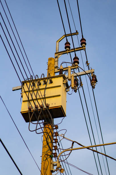 istock High Voltage Electrical Power Grid with Power Poles and Transmission Lines in Urban Setting 2162967487