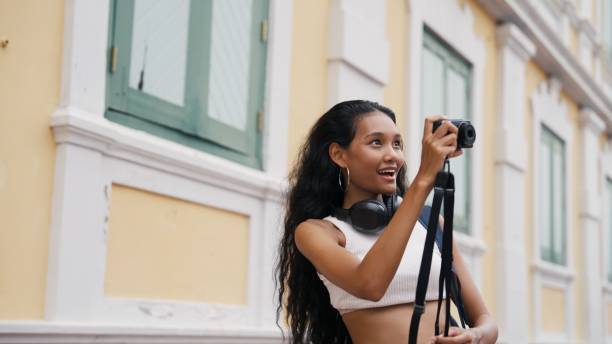 istock Woman holding a travel camera 2162967568