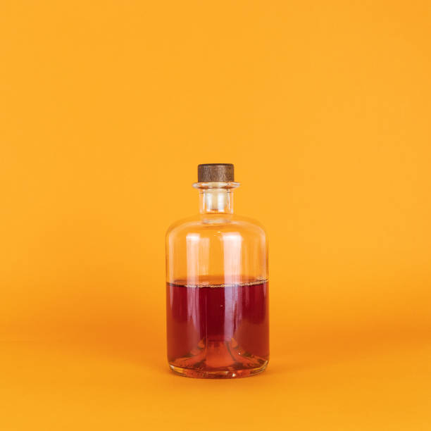 istock Whiskey Whisky Bottle Half In Orange background Studio lighting 2162967790