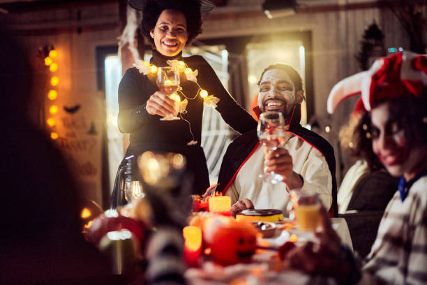 istock Happy black parents enjoying during Halloween in dining room. 2162967910
