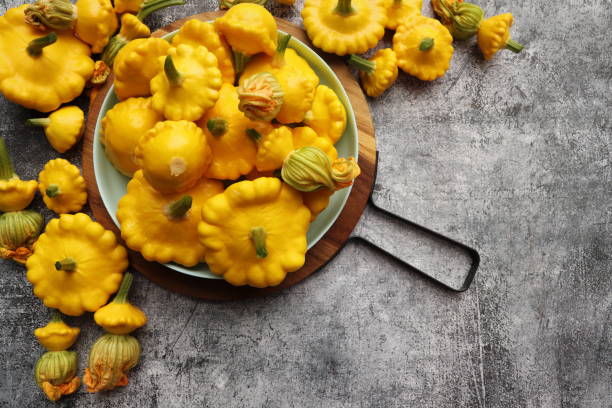 istock Yellow patisson, pattypan scallop squash vegetable on blue plate on white marble table background. Top view, flat lay. Autumn, fall harvest concept 2162968091