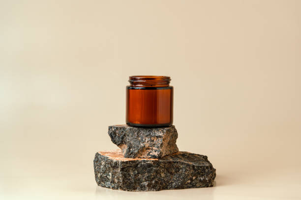 istock Glass Jar On Stacked Rocks Against Beige Background 2162969550