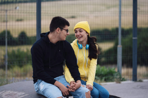 istock Casually dressed couple smiling and holding hands outside 2162970224
