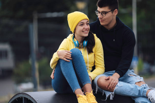 istock Young couple bonding on ramp in outdoor setting. 2162970252
