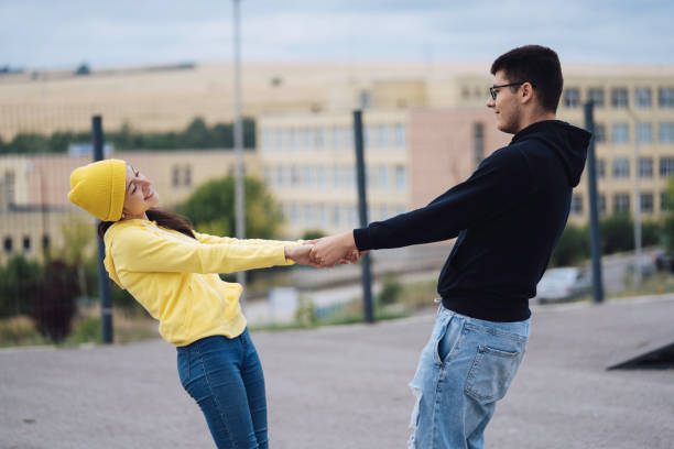 istock Two people happily holding hands and leaning backward joyfully 2162970261