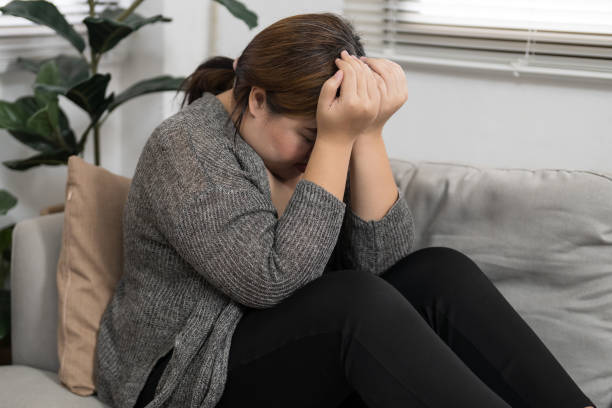 istock Sad Overweight plus size woman thinking about problems on sofa upset girl feeling lonely and sad from bad relationship or Depressed woman disorder mental health. 2162972807