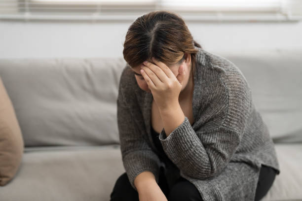 istock Sad Overweight plus size woman thinking about problems on sofa upset girl feeling lonely and sad from bad relationship or Depressed woman disorder mental health. 2162972809