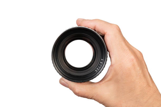 istock Closeup of a Camera Lens Held in a Hand Isolated On a White Background 2162972848