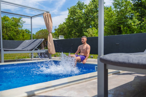 istock Young man vibing by the pool 2162974022