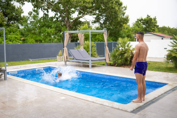 istock Young man vibing by the pool 2162974048