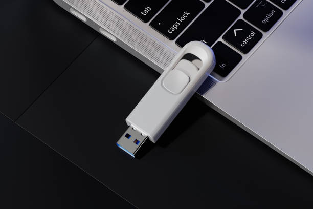 istock USB flash drive near the laptop mockup. 3D rendering 2162974197