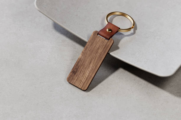 istock Vintage wooden key ring with leather holder mockup. 3D rendering 2162974212