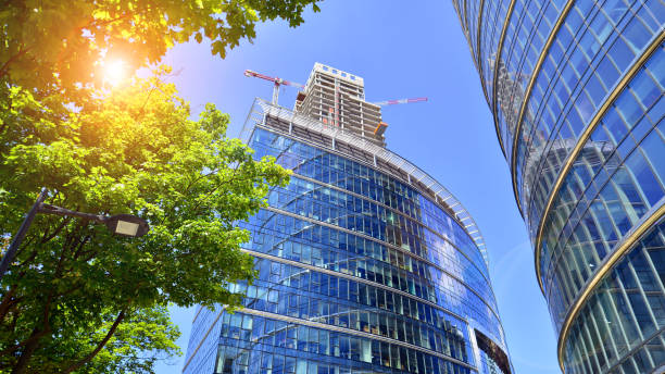 istock Sustainable glass office building with trees for reducing carbon dioxide. Eco-friendly building in modern city. 2162974779