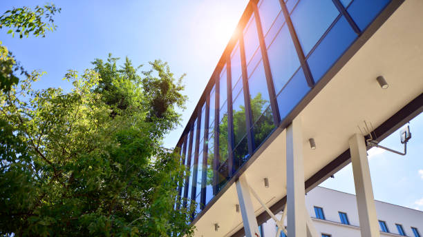 istock Sustainable glass office building with trees for reducing carbon dioxide. Eco-friendly building in modern city. 2162974799