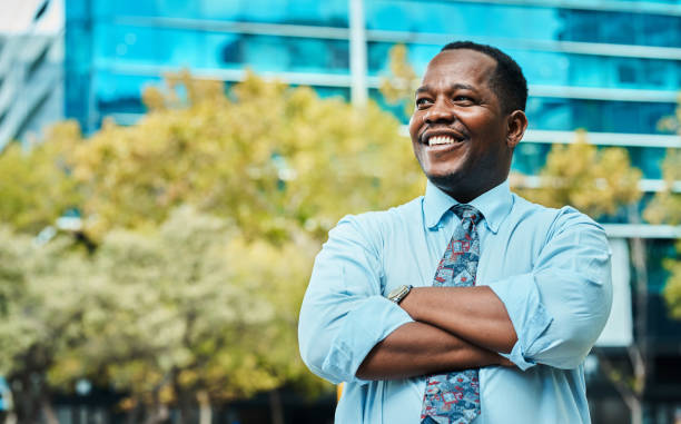 istock Confident Black Businessman Smiling Outdoors in City Setting 2162976209