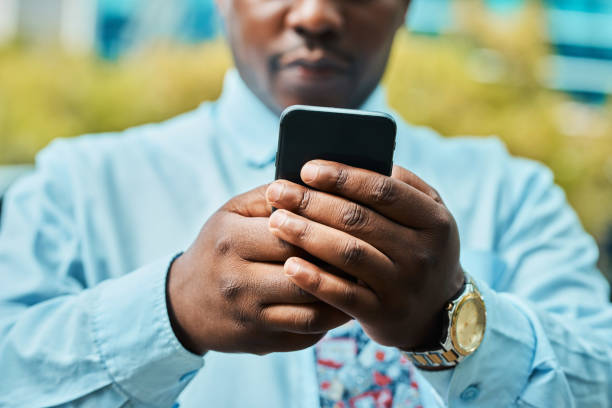 istock Black Businessman Using Smartphone in City for Communication and Work 2162976237