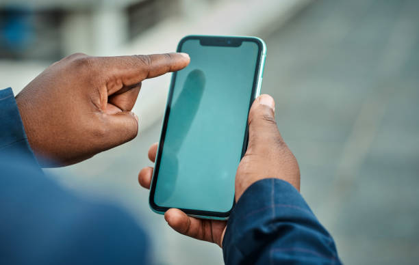 Black Businessman Using Smartphone in City, Close-Up of Hand and Mobile Device