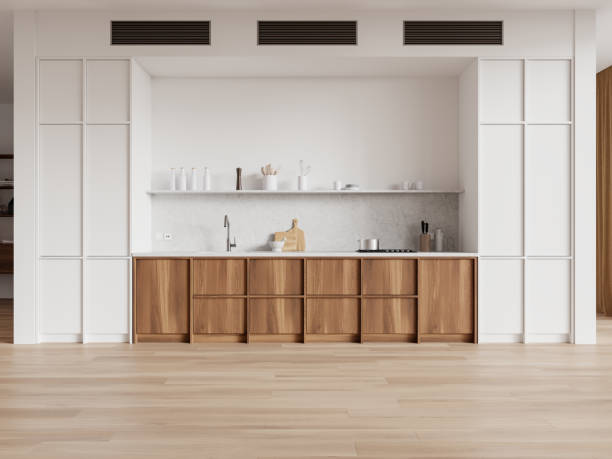 istock Modern kitchen with white cabinets and wooden lower drawers, marble countertop, and kitchenware on light wood flooring. Home interior, minimalist design. 3D Rendering 2162977075