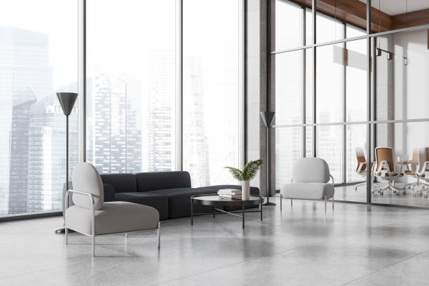 istock Office lounge zone interior with sofa and armchairs, meeting room and window 2162977597