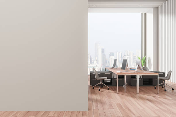 istock Coworking interior with armchairs and pc computers near window. Mockup wall 2162978124