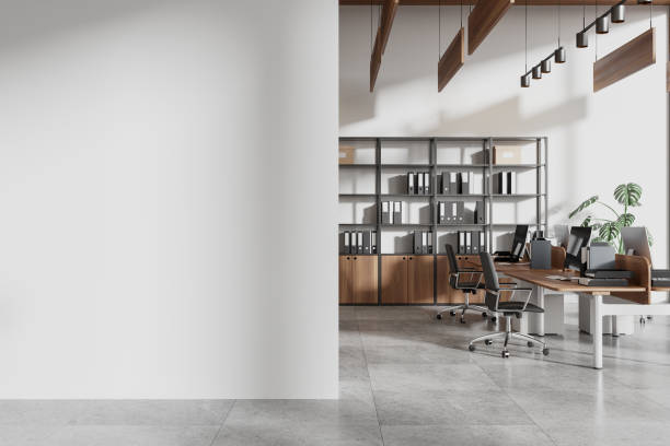 istock Coworking interior with pc monitors and chairs in row. Mockup wall 2162978591