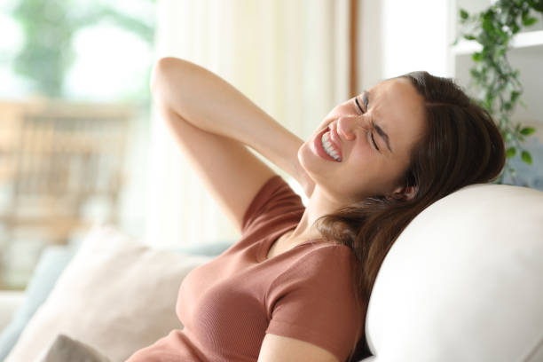 istock Stressed woman complaining suffering neck ache on a couch 2162979473