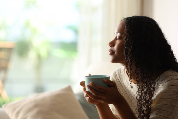 istock Black woman at home drinking coffee and relaxing 2162979516