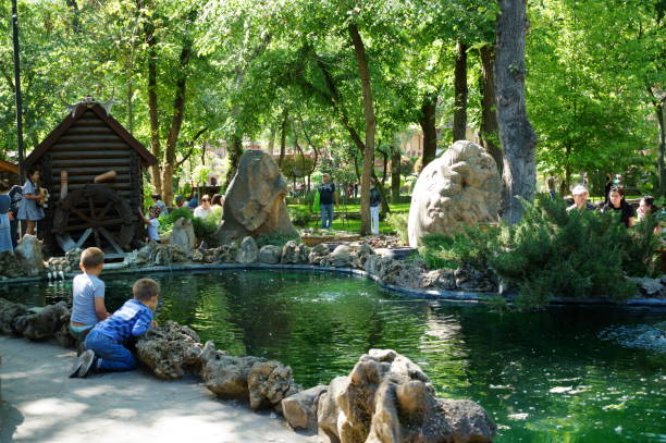 Russia. Kamensk Shakhtinsky, June 2024. Loga Park, people relax near a small pond.