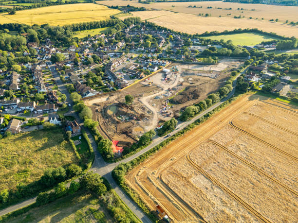 Harvested wheat and barley fields seen adjacent to an Essex village in the UK. stock photo