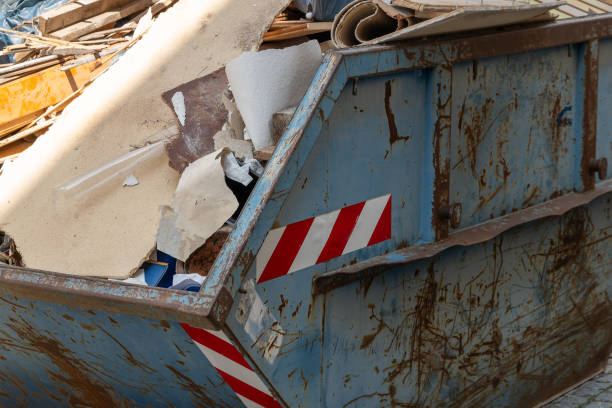 dumpster is full of trash and has a red and white striped sticker on it stock photo