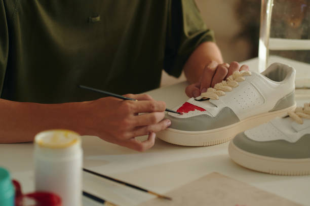 istock Designer Painting Custom Sneakers At Table 2162982345