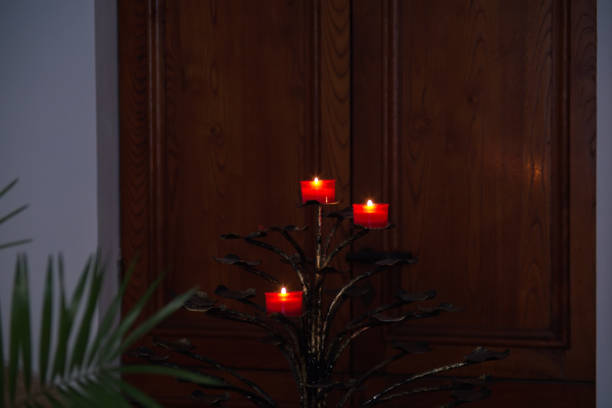 small votive candles lit against a door