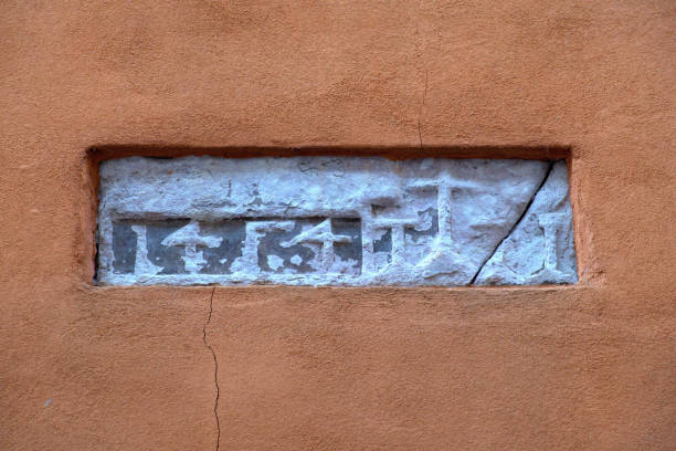 istock ancient symbols and numbers on a wall 2162988751