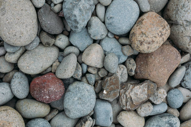 Abstract smooth round pebbles sea texture background. Stones in Faroe island